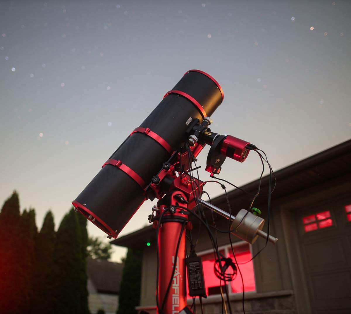 my telescope tracking the night sky in the backyard